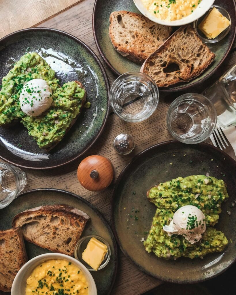 A delicious brunch featuring avocado toast and poached eggs in Alfortville, France.